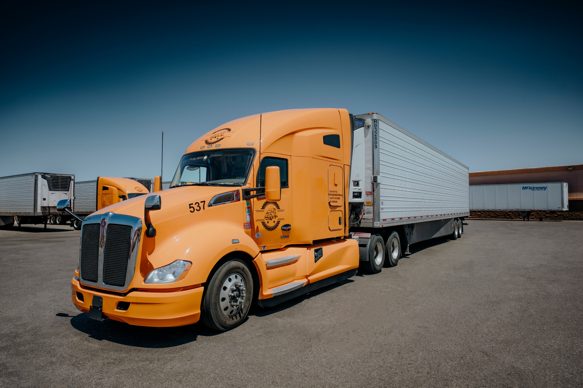 US Express Carriers orange semi truck with reefer trailer